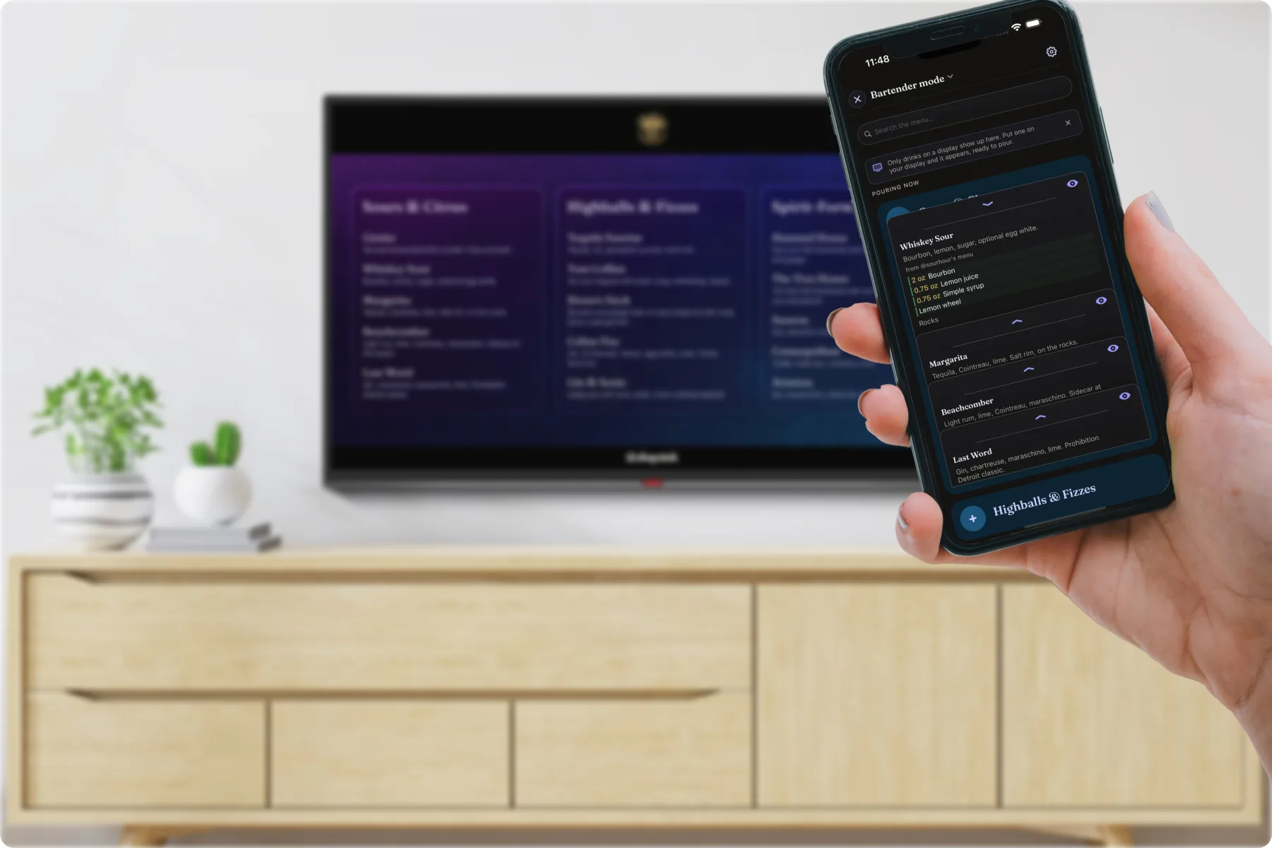 Bartender Mode in hand showing ratios and technique while the guest menu shows on the TV behind